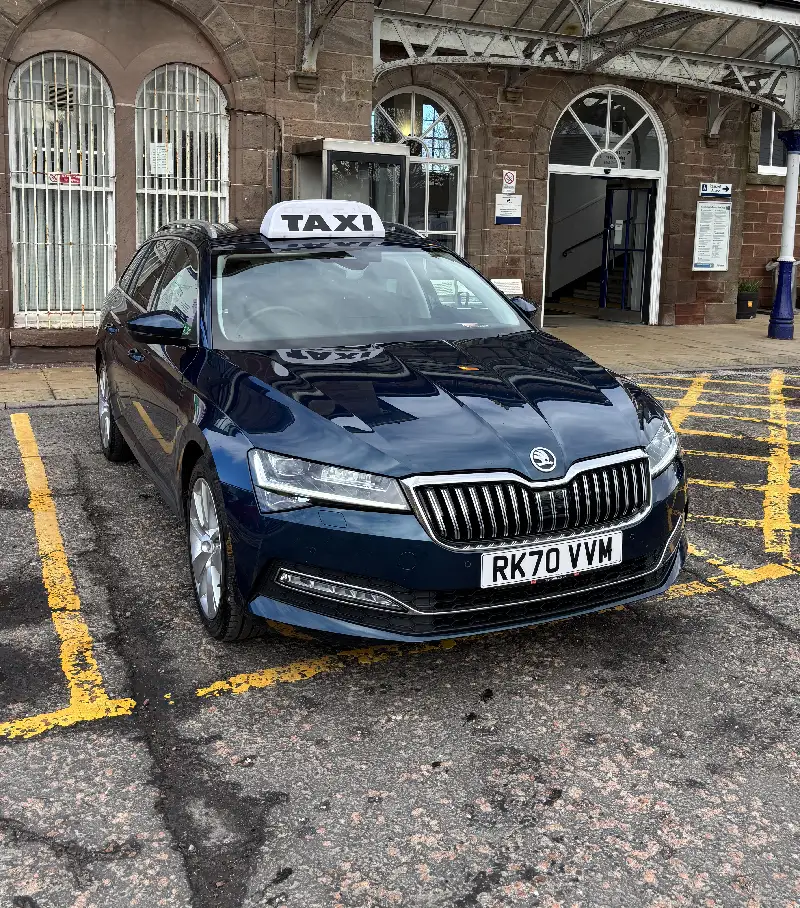 Very shiny dark blue car with taxi sign on the roof
