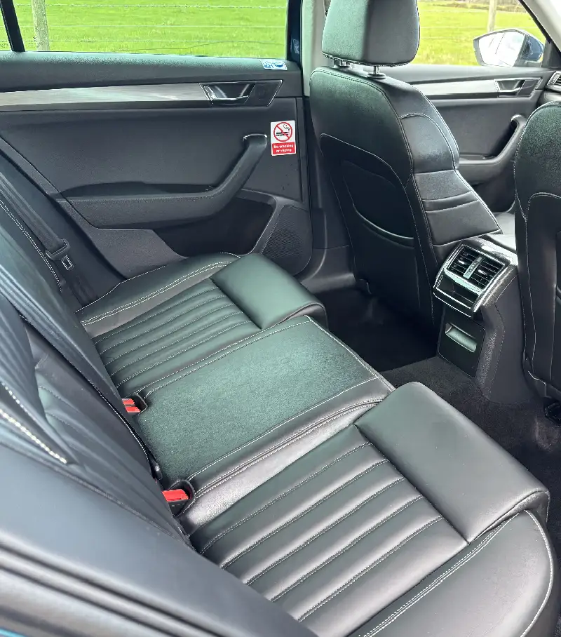 Rear seats of a Skoda Superb taxi taken from the open drivers side rear door